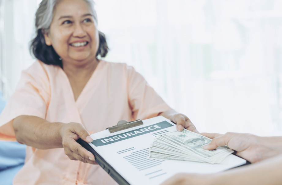 Older woman receiving an insurance document and cash, symbolizing long-term care insurance
