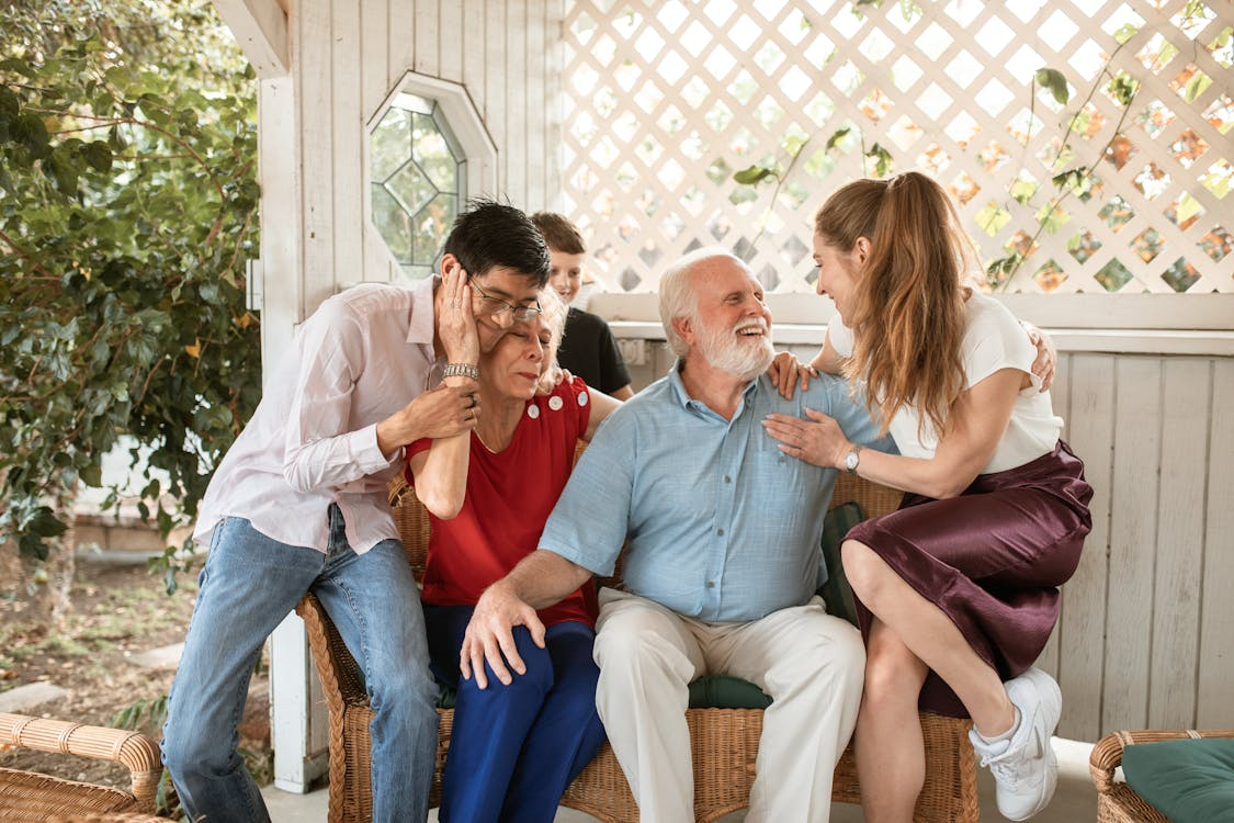 Grandparents surrounded by children and family, balancing love with financial security
