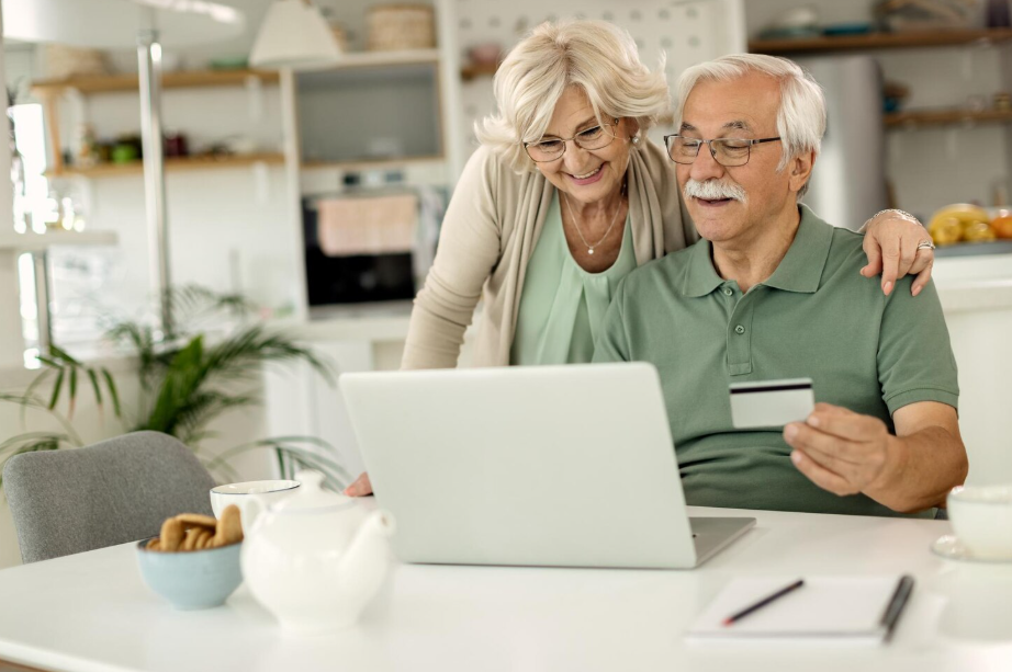 Senior couple reviewing finances online together with peace of mind after 50
