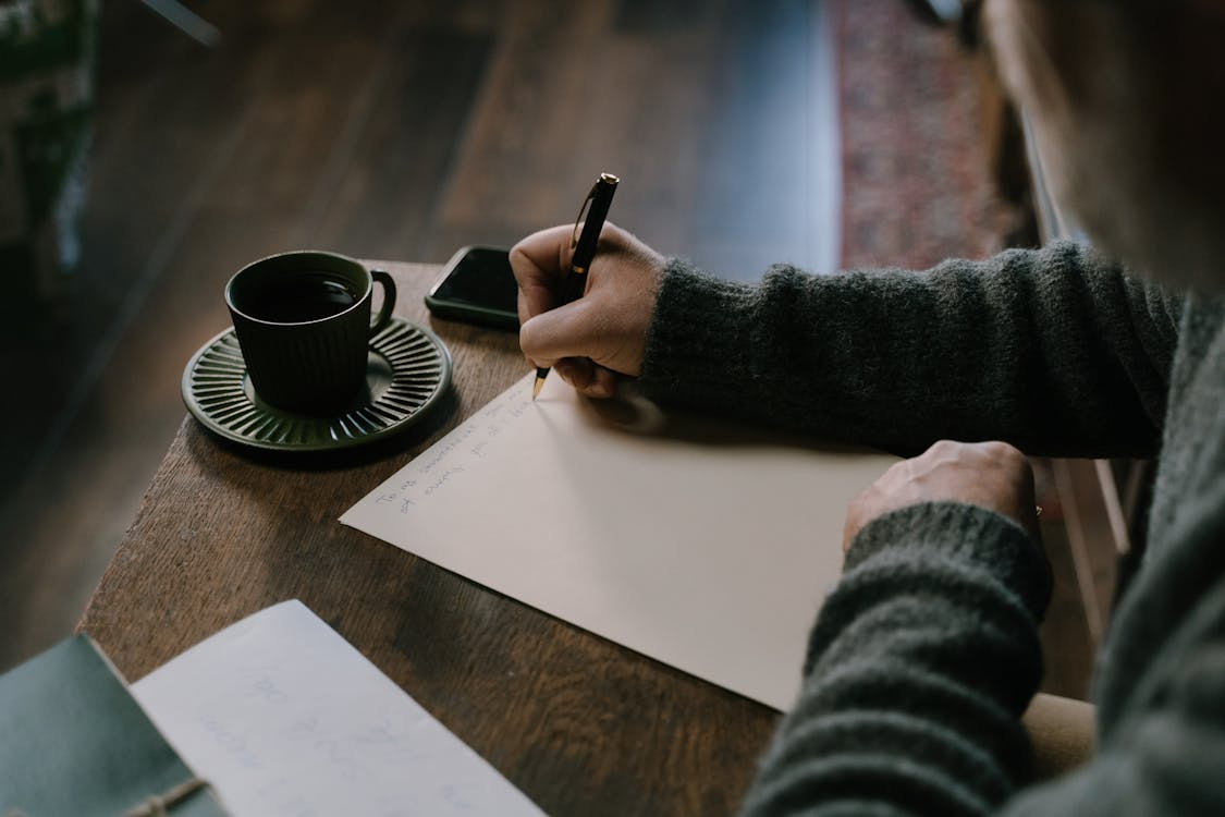 Older adult writing life goals in a notebook to create a 20-year life map