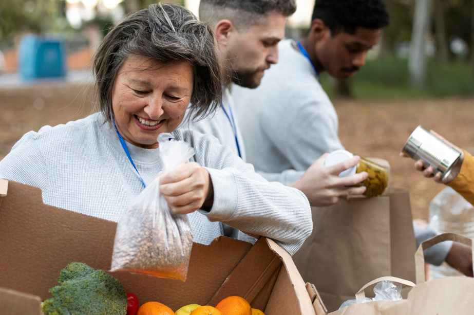 Retired woman volunteering at a community food drive,