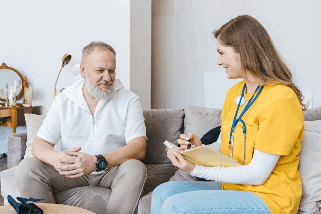 Senior man consulting with a healthcare professional at home, discussing plans for unexpected life transitions after 50