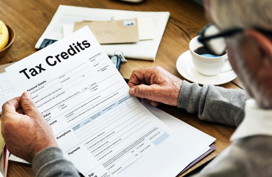 Older man reviewing tax credit documents as part of tax-smart retirement planning strategy