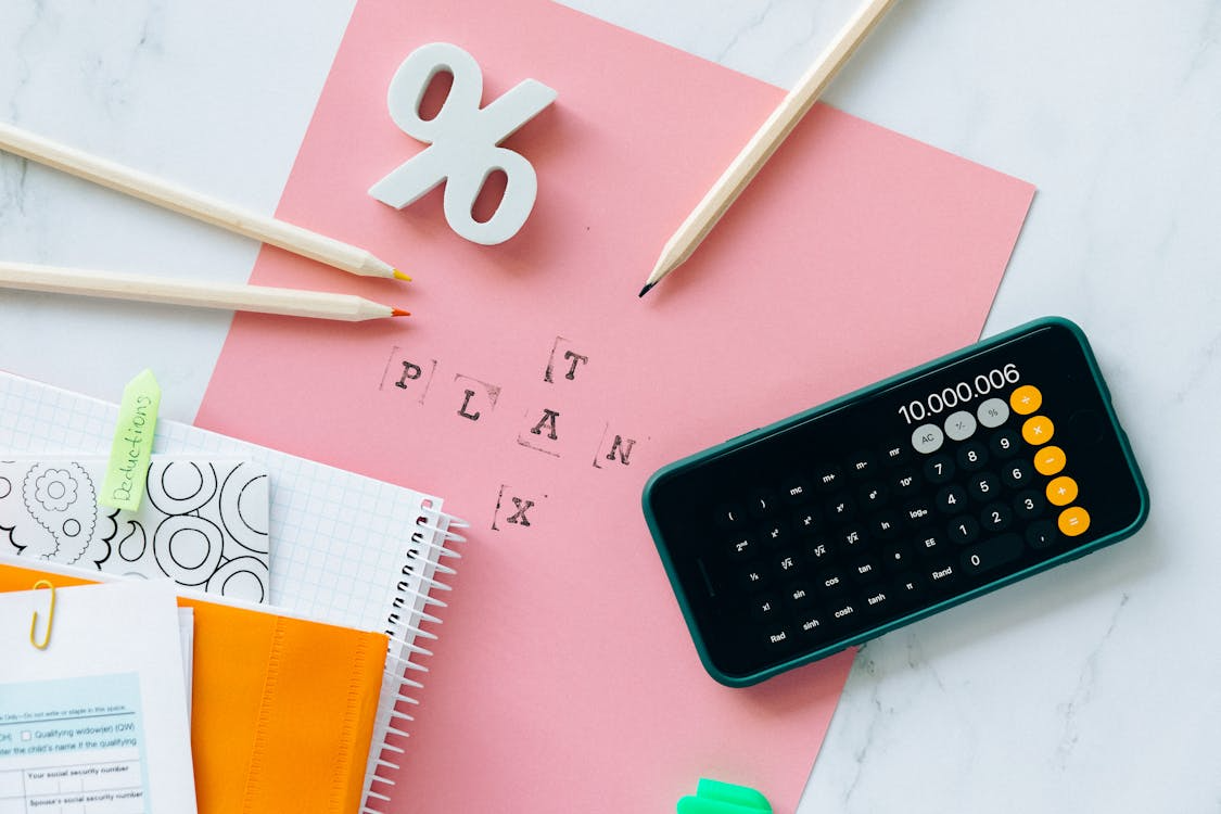 Tax planning setup with calculator, notes, and deductions folder for semi-retirees and consultants